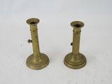 pair of antique brass candlesticks on a white background
