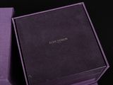 the purple box is open to show the contents of the watch