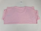 a pink t - shirt on a white surface with a tag