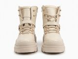 a pair of beige leather boots with laces on the sole