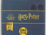 a close up of a book with a harry potter badge on it