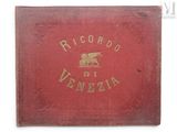 an old red book with gold writing and a picture of a horse on it