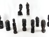 a lot of statues that are sitting on a white surface