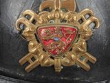 a close up of a helmet with a coat of arms on it