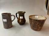 three vases sitting next to each other on a table
