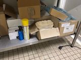 une table en métal sur laquelle sont posées des boîtes et d'autres objets