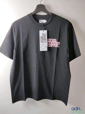 a black t - shirt with a pink logo on the front