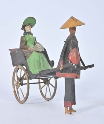 a figurine of a woman and a man in a carriage