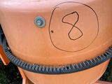 a clay pot sitting on top of a cement mixer