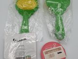 a plastic brush and a plastic ball on a table