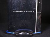 a video game console and a game controller on a black background