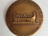 a close up of a gold medal with a boat on it