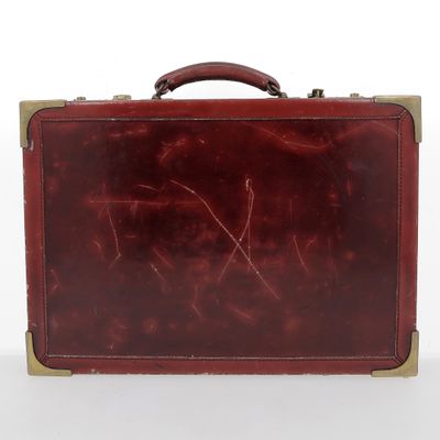 brown leather suitcase with handle on a white surface