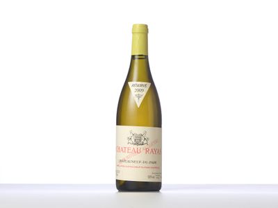 the bottle of white wine is sitting on the table