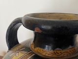 a vase that is sitting on a table next to a wall