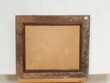 an old picture frame sitting on top of a wooden shelf