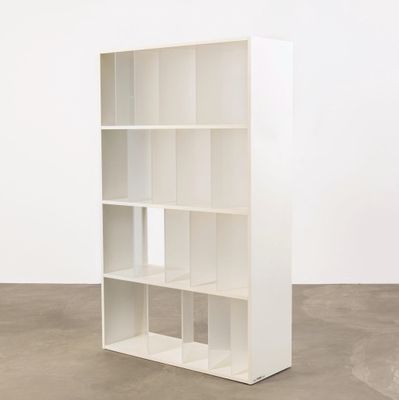 an image of a white bookcase in an empty room