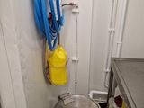 a pot and a hose in a small room