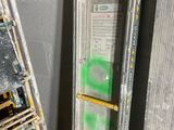 a ladder leaning against a wall next to a ladder with a sign on it
