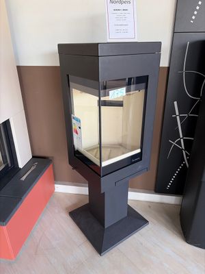 a glass display case with a fish in it in the corner of a room
