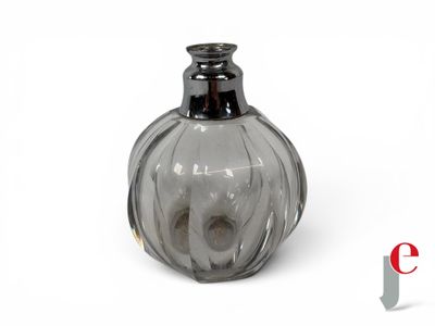 a small glass vase with a black top on a white surface