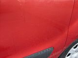a red car that is parked on the side of the road