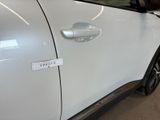a white car with a sticker on the side of it