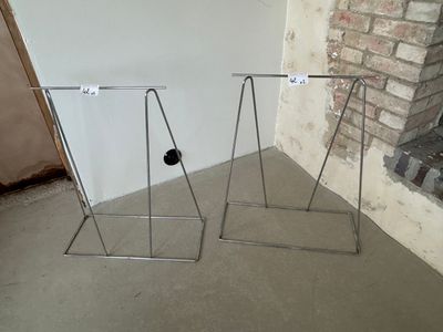 two racks that are standing in front of a brick wall