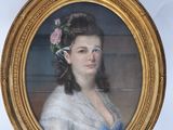 portrait of a woman in a blue dress with a flower in her hair