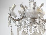 a crystal chandelier hanging from a ceiling in a room