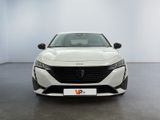 the front view of a white car in a white room
