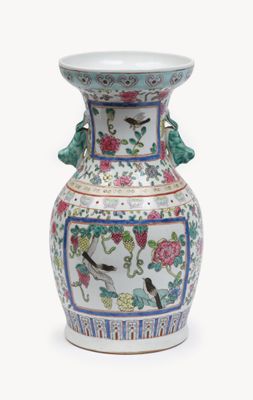 a vase with a bird and flowers design on it