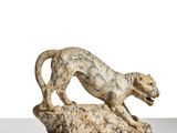 an image of a statue of a leopard on a rock