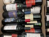 many bottles of wine in a box on the floor