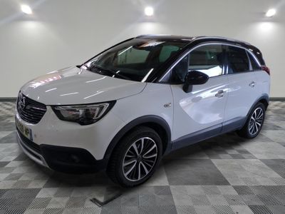 la voiture blanche est garée sur le sol à carreaux d'un garage