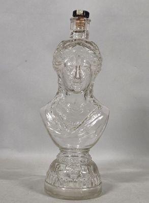 a glass bottle with a glass bust on it