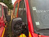 two fire trucks parked next to each other on the side of the road