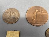 two medals and a medal are on a table next to each other