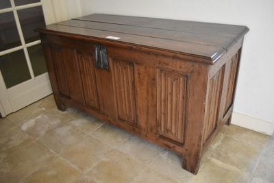 an image of a wooden chest in the corner of a room