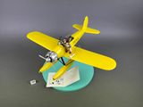 a model of a yellow airplane on a blue plate