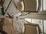 a toilet in the middle of a room with many chairs