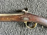 an old gun that is laying on the ground