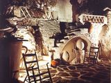 an old photo of a stone house with a fire place