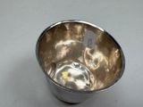 a silver cup that is sitting on a table