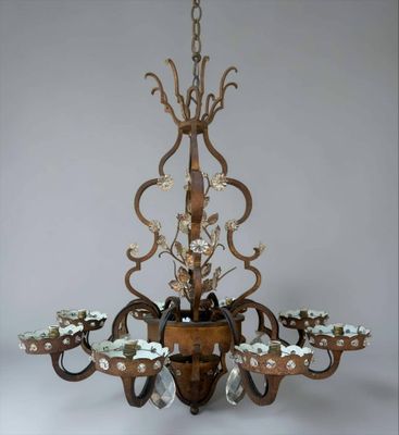 a chandelier made of wood and metal with flowers and leaves