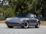 an image of a grey porsche parked in a parking lot