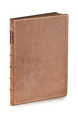 an old book with a brown cover sitting on top of a white surface