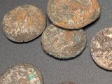 some old coins sitting on top of a table next to each other