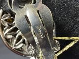a close up of a metal object on a black surface