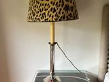 a lamp that is on top of a table next to a bed